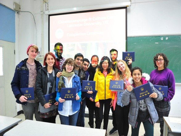 Teachers and students have group photo taken together